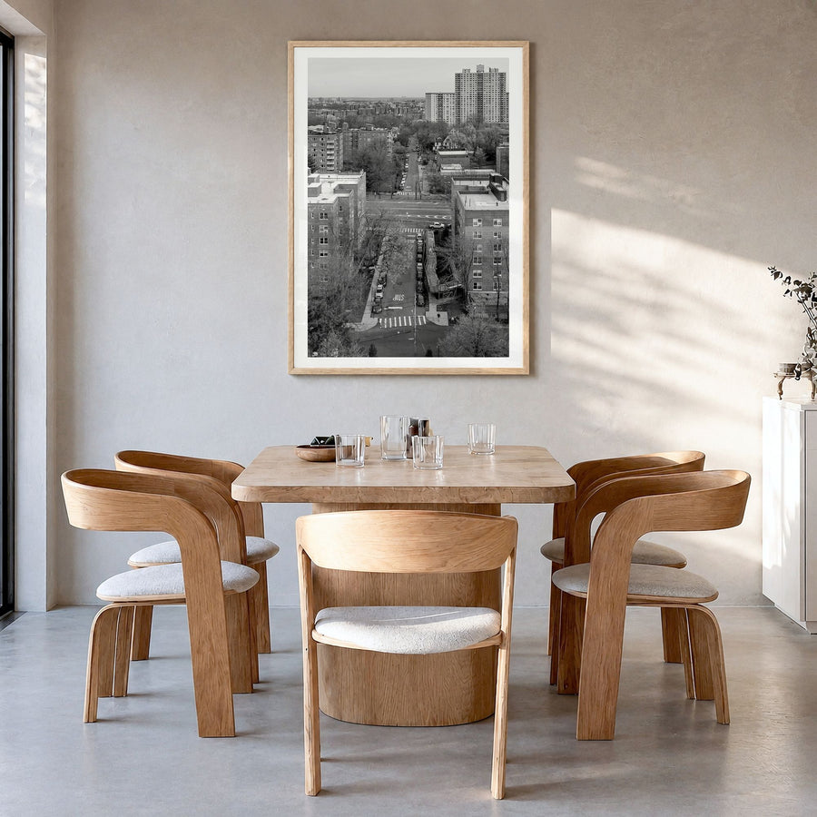 The Bronx Photo Poster in a natural wood frame, hanging in a dining room, white border