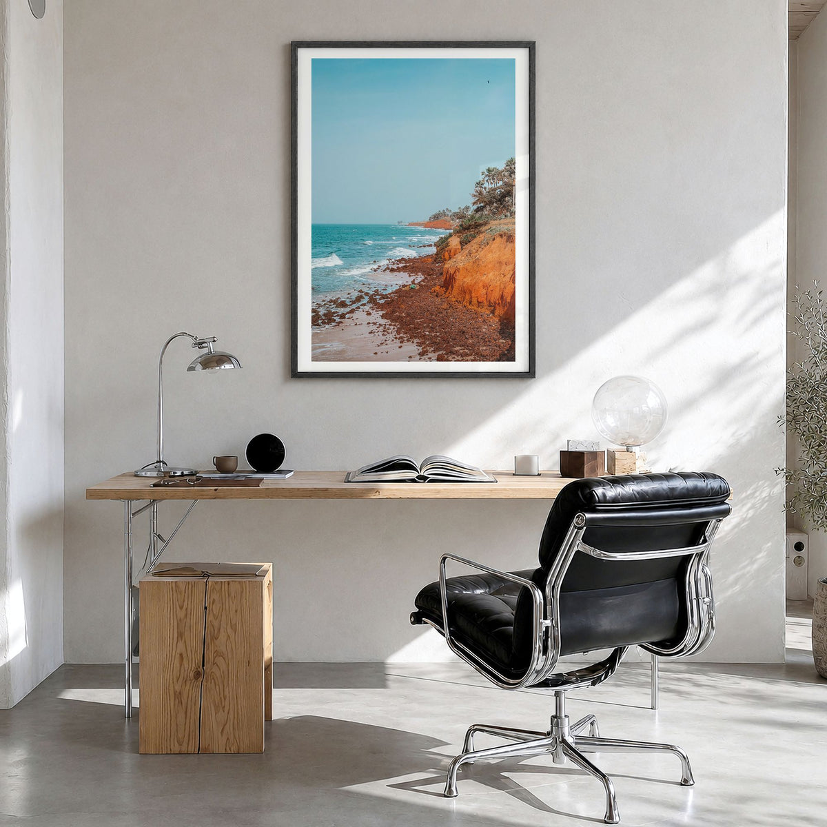 The Gambia Photo Poster in a black wood frame, hanging in a bright home office, white border