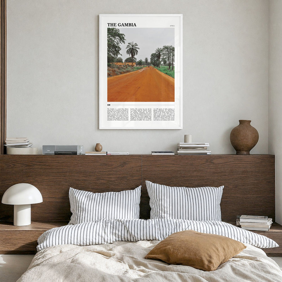 The Gambia Travel Poster in a white wood frame, hanging in a bedroom