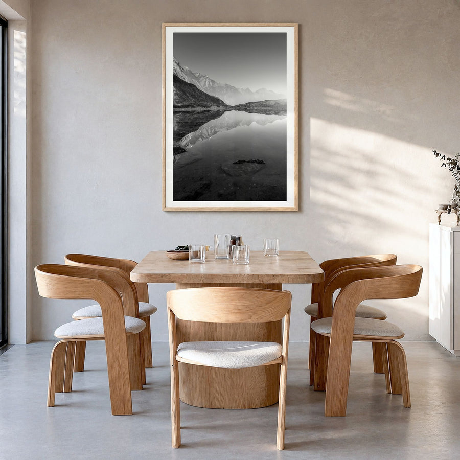 The Himalayas Photo Poster in a natural wood frame, hanging in a dining room, white border