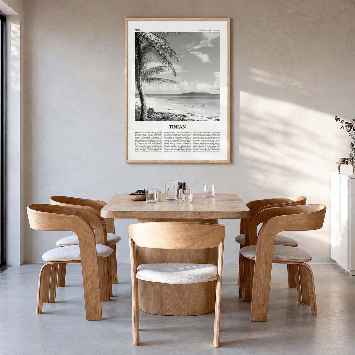 Tinian Newspaper Poster in a natural wood frame, hanging in a dining room