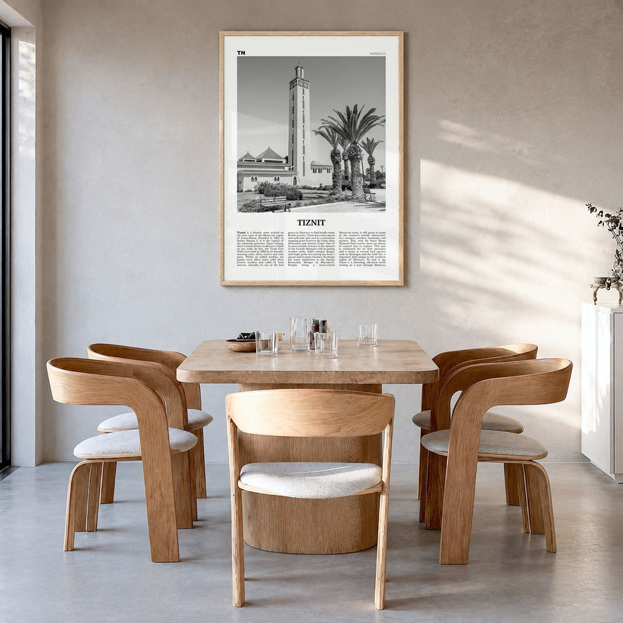 Tiznit Newspaper Poster in a natural wood frame, hanging in a dining room