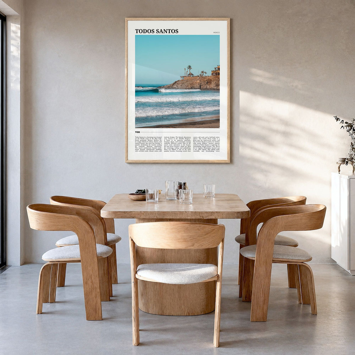 Todos Santos Travel Poster in a natural wood frame, hanging in a dining room