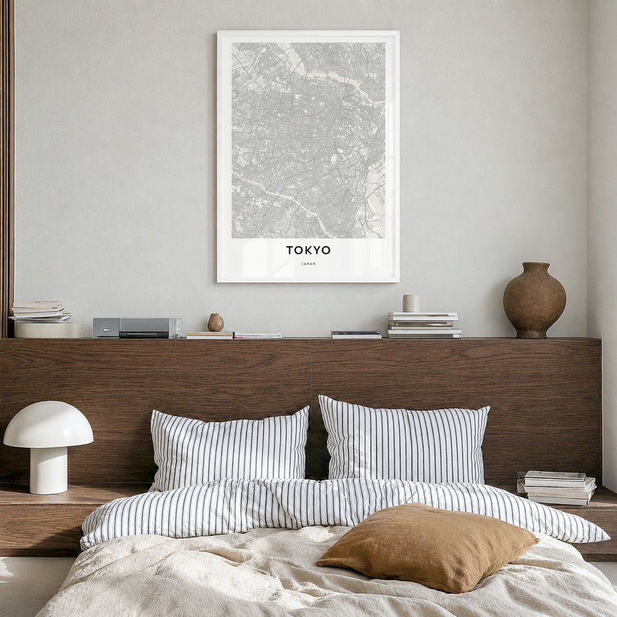 Tokyo Map Poster in a white wood frame, hanging in a bedroom
