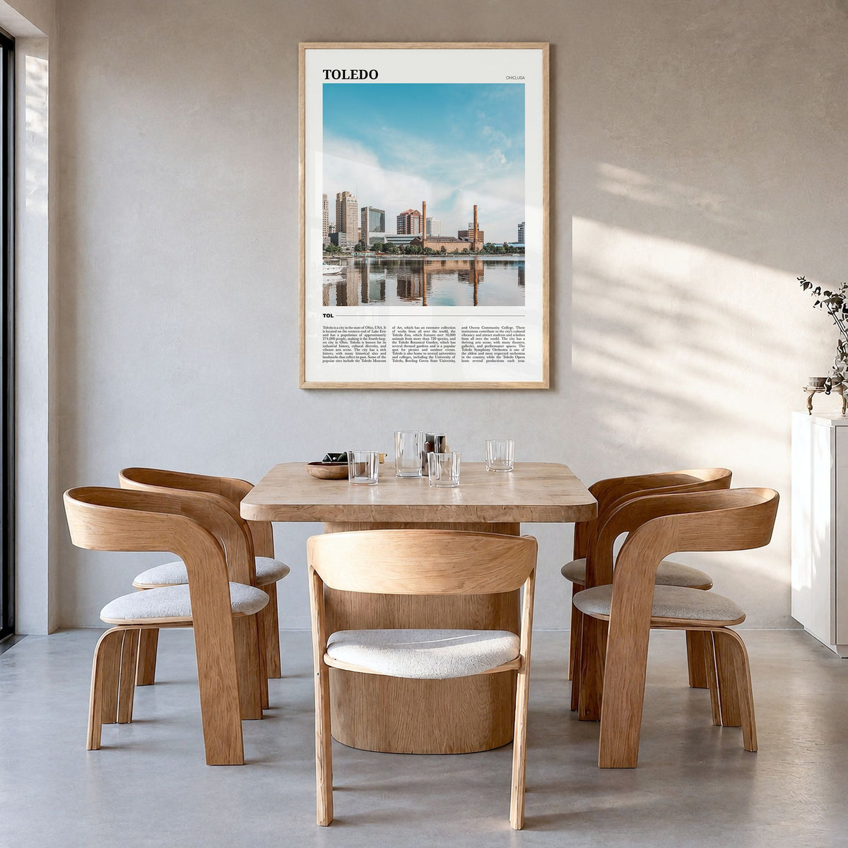 Toledo, Ohio Travel Poster in a natural wood frame, hanging in a dining room