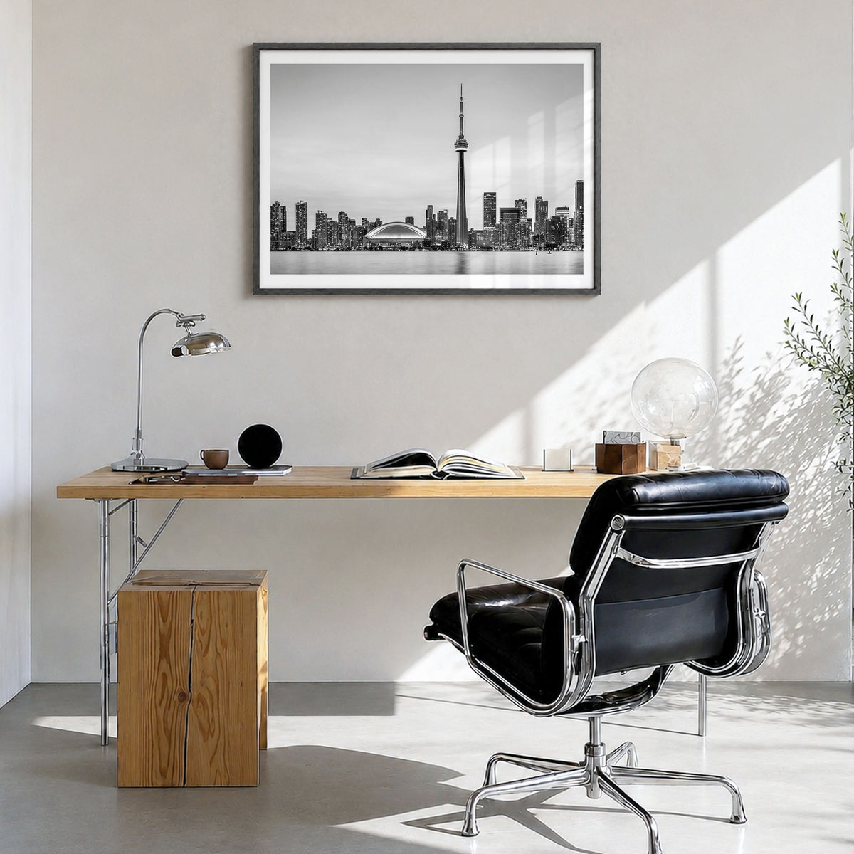 Toronto Photo Poster in a black wood frame, hanging in a bright home office, white border