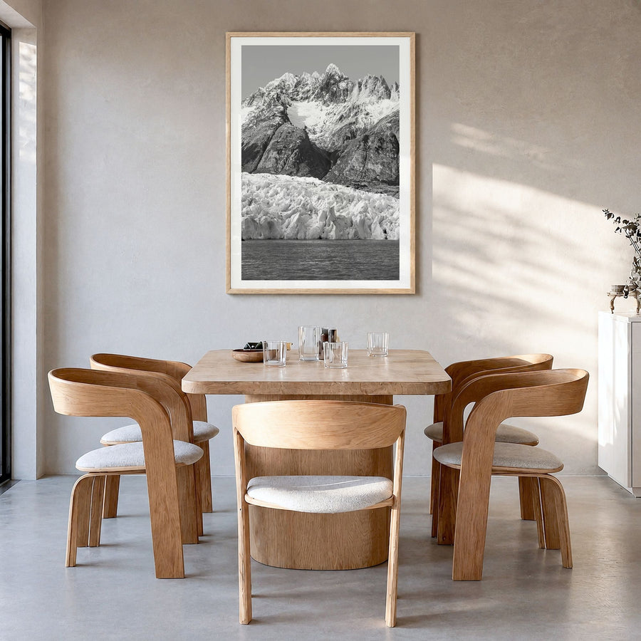 Torres del Paine Photo Poster in a natural wood frame, hanging in a dining room, white border