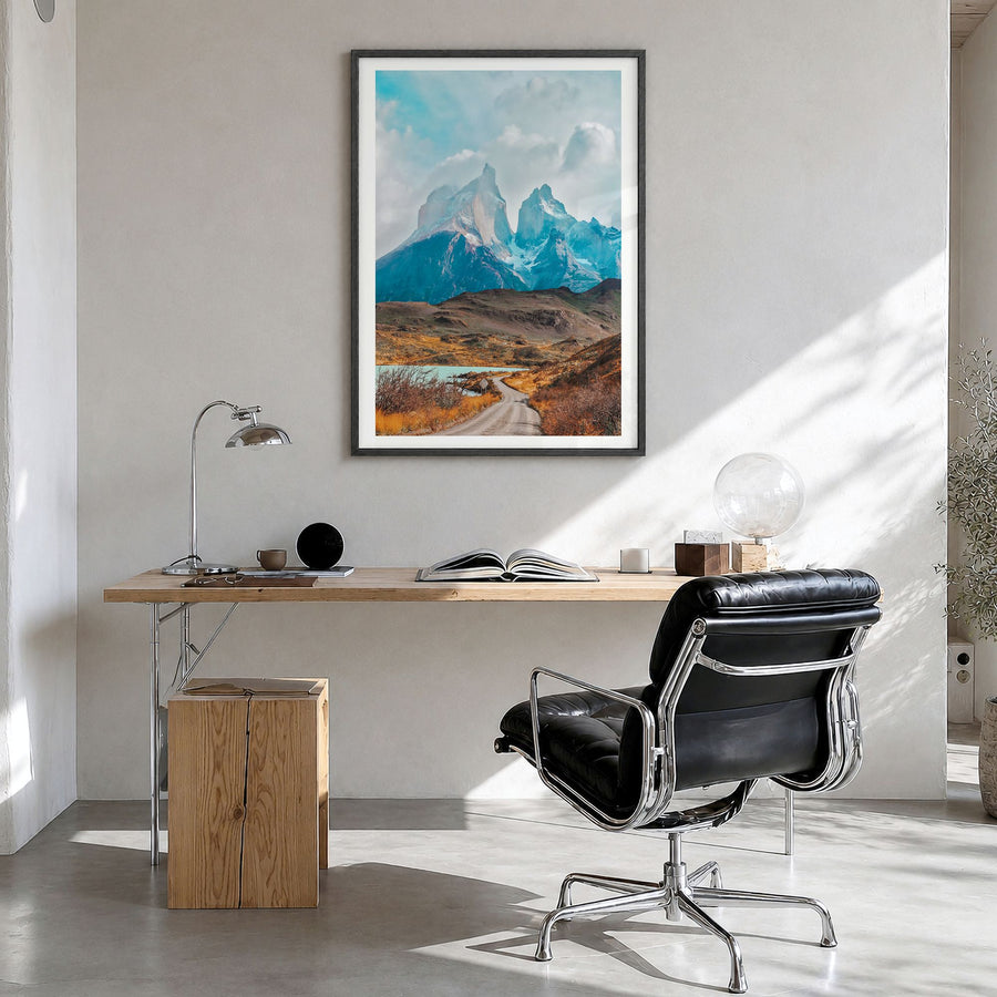 Torres del Paine Photo Poster in a black wood frame, hanging in a bright home office, white border