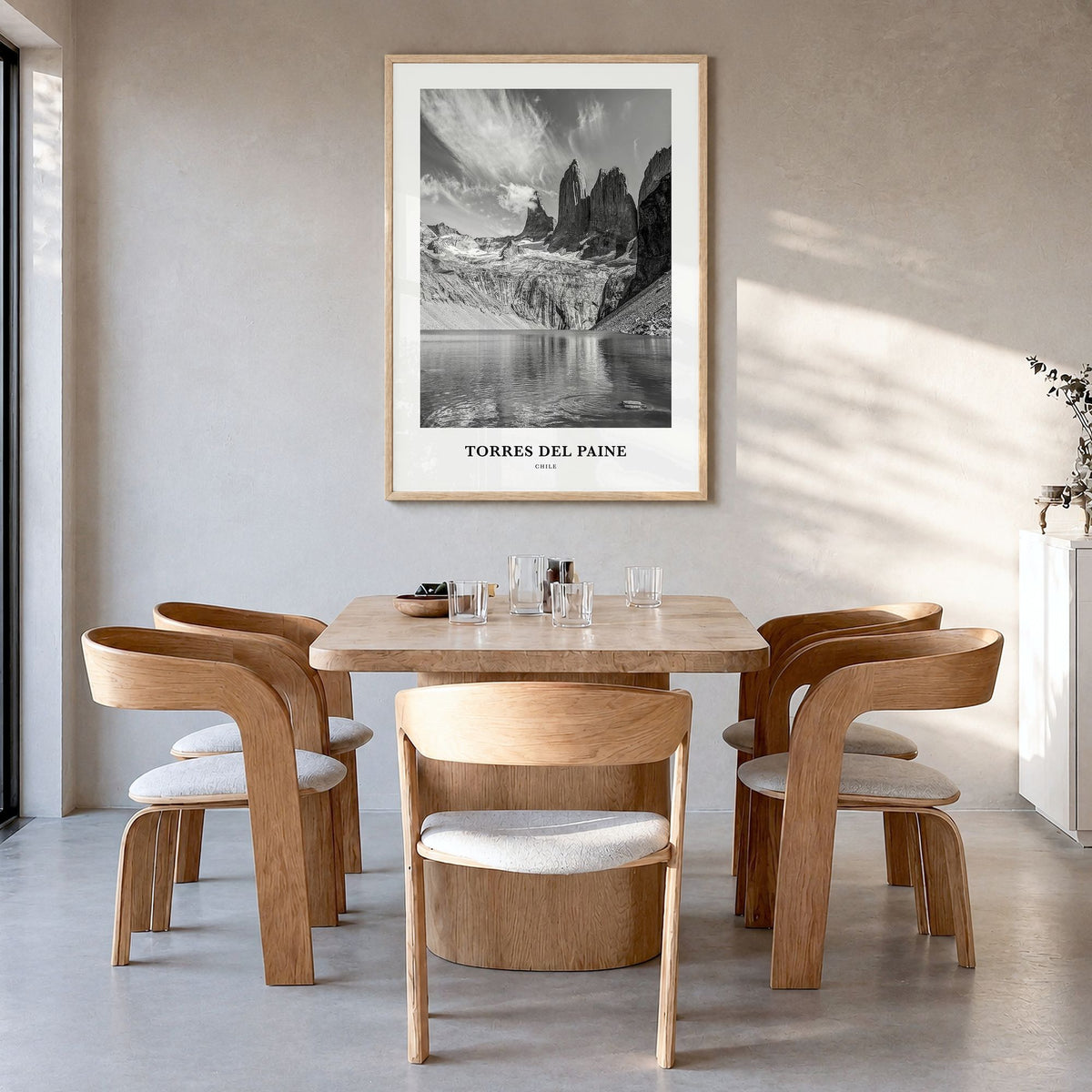 Torres del Paine Classic Poster in a natural wood frame, hanging in a dining room