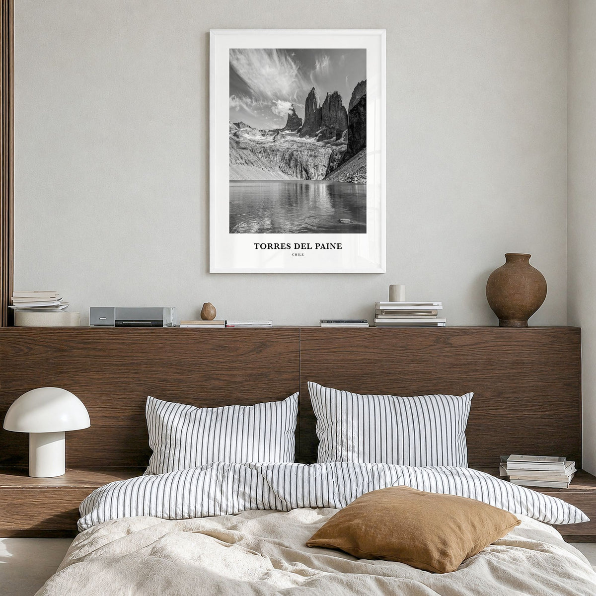 Torres del Paine Classic Poster in a white wood frame, hanging in a bedroom