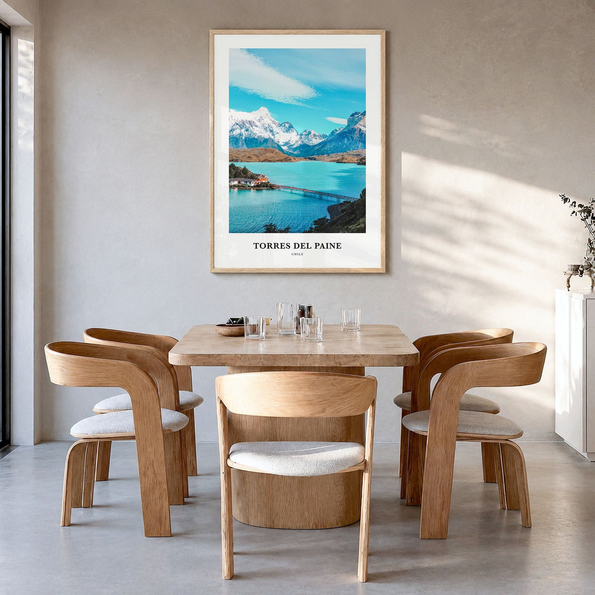 Torres del Paine Classic Poster in a natural wood frame, hanging in a dining room