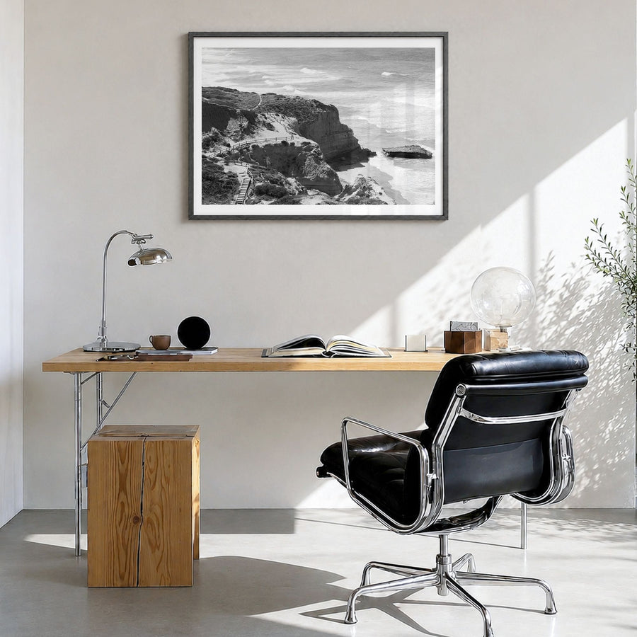 Torrey Pines Photo Poster in a black wood frame, hanging in a bright home office, white border