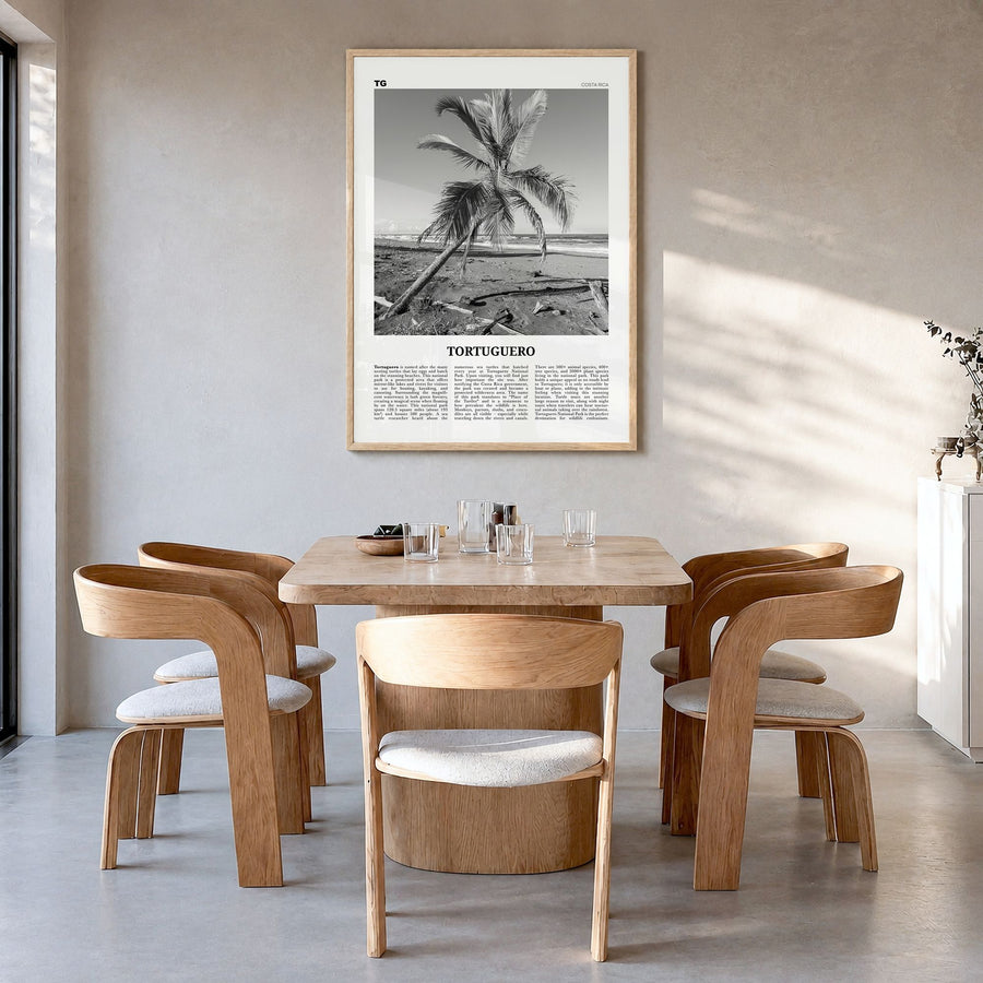 Tortuguero Newspaper Poster in a natural wood frame, hanging in a dining room