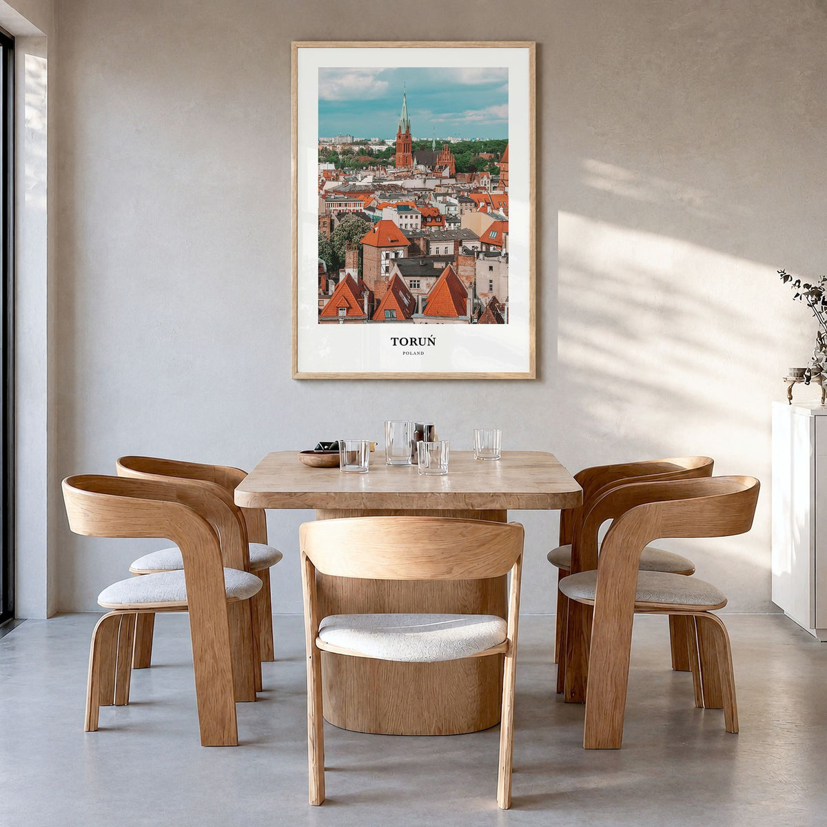 Toruń Classic Poster in a natural wood frame, hanging in a dining room
