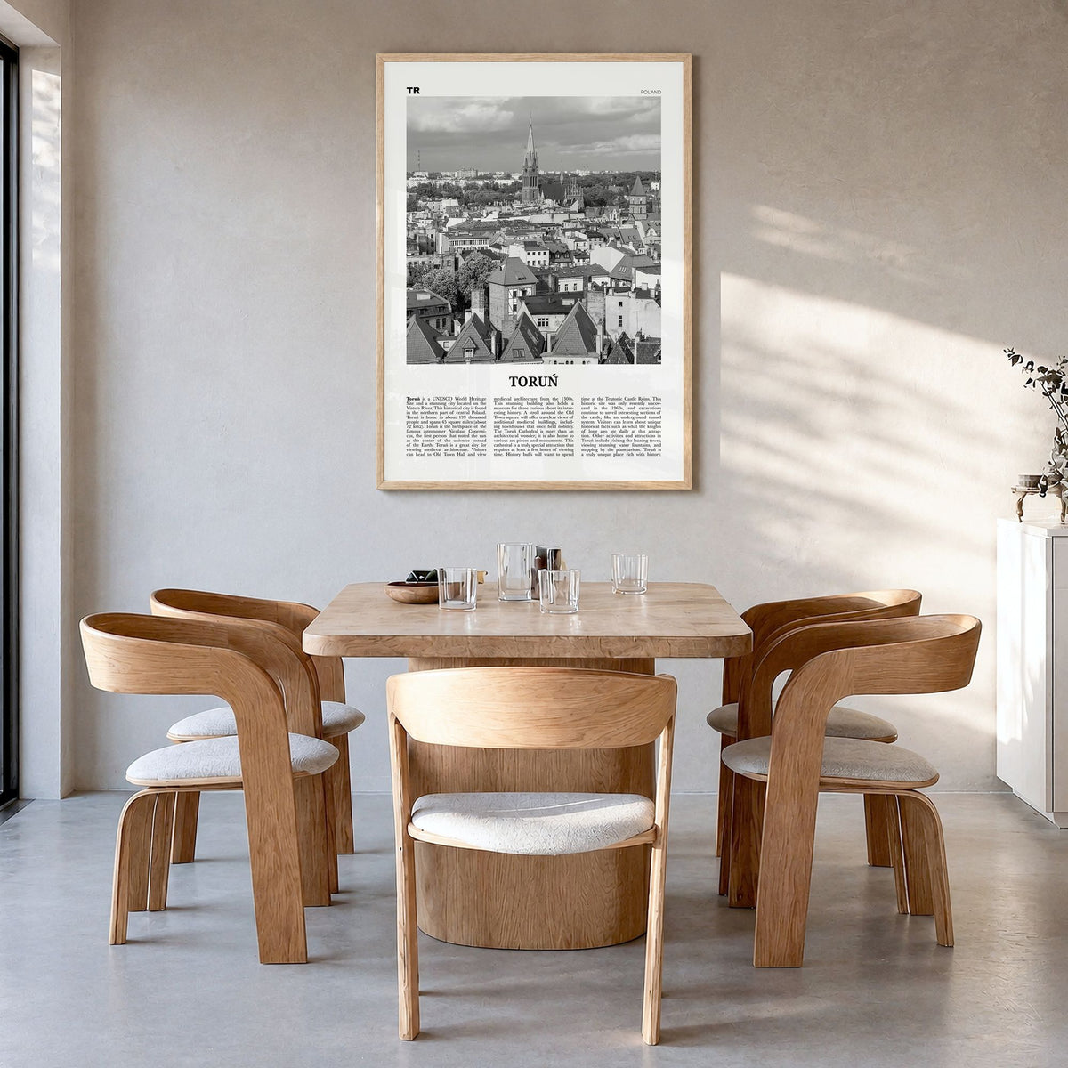 Toruń Newspaper Poster in a natural wood frame, hanging in a dining room