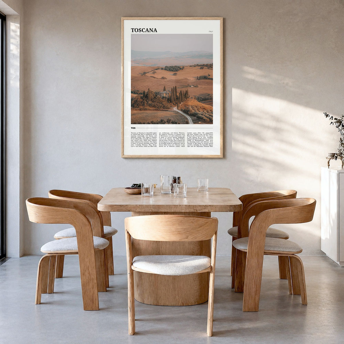 Toscana Travel Poster in a natural wood frame, hanging in a dining room