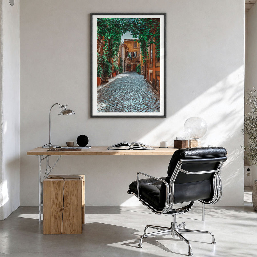 Trastevere Photo Poster in a black wood frame, hanging in a bright home office, white border