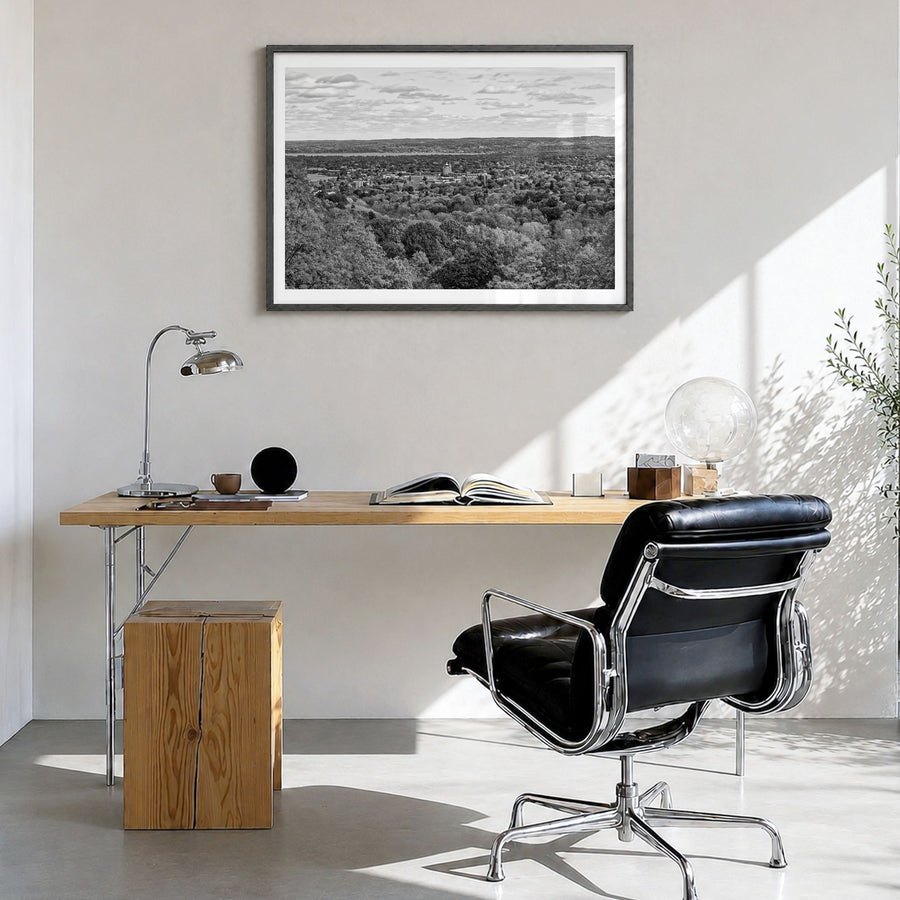 Traverse City Photo Poster in a black wood frame, hanging in a bright home office, white border