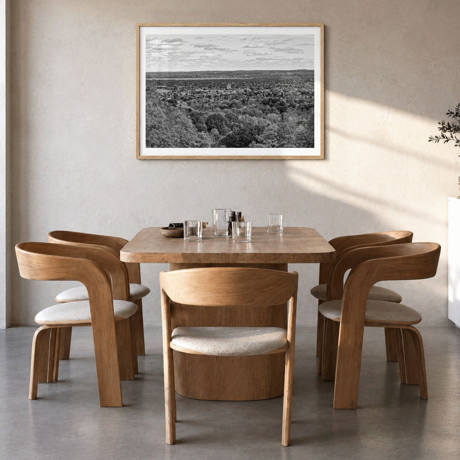 Traverse City Photo Poster in a natural wood frame, hanging in a dining room, white border