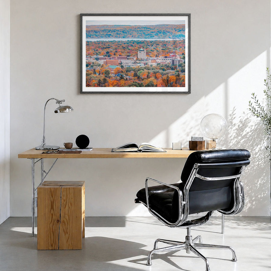 Traverse City Photo Poster in a black wood frame, hanging in a bright home office, white border