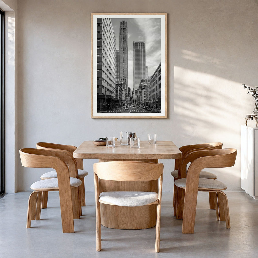Tribeca Photo Poster in a natural wood frame, hanging in a dining room, white border