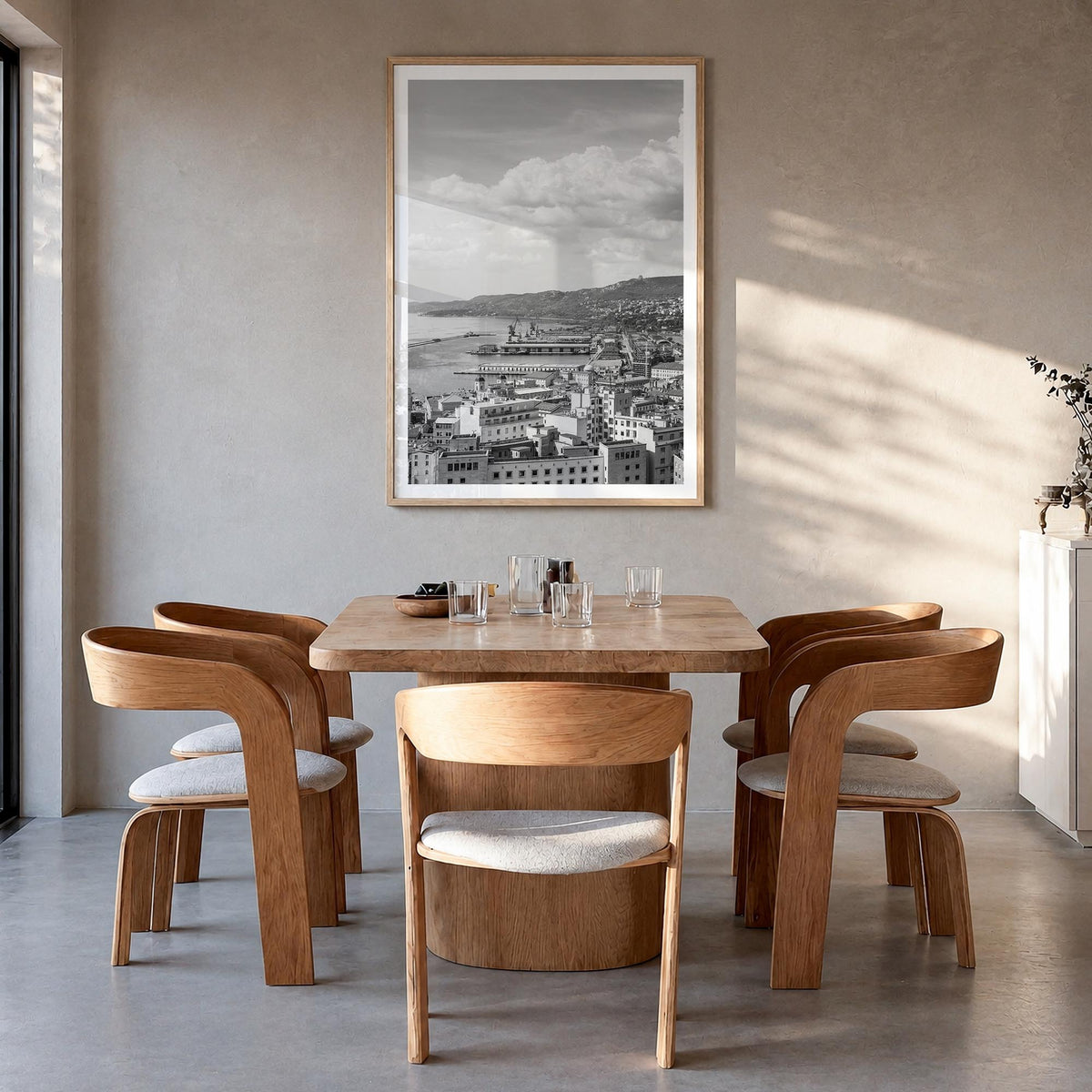 Trieste black & white photo poster of Italy – vertical wall art in natural wood frame with white border, hanging on wall