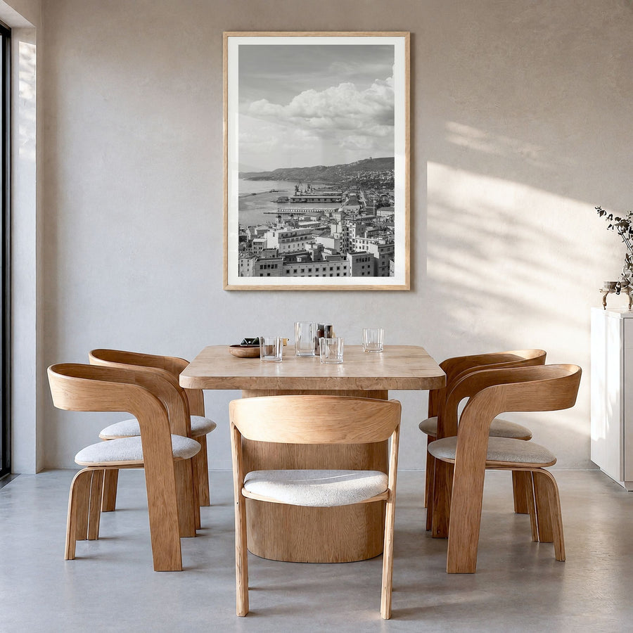 Trieste Photo Poster in a natural wood frame, hanging in a dining room, white border