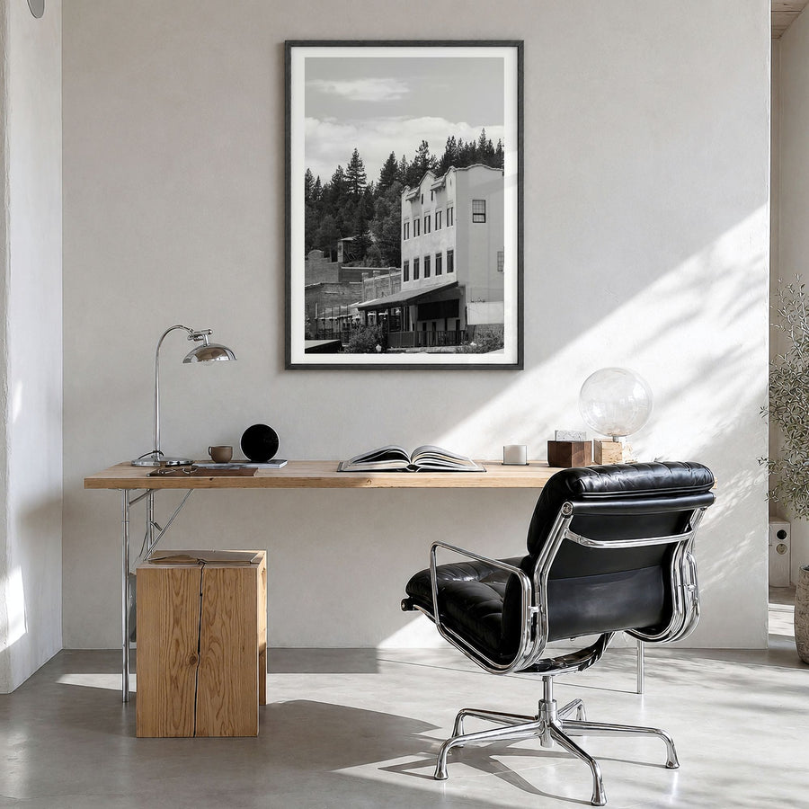 Truckee Photo Poster in a black wood frame, hanging in a bright home office, white border