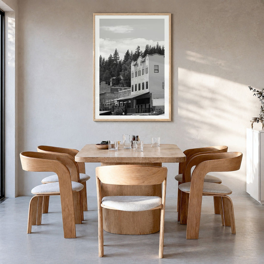 Truckee Photo Poster in a natural wood frame, hanging in a dining room, white border