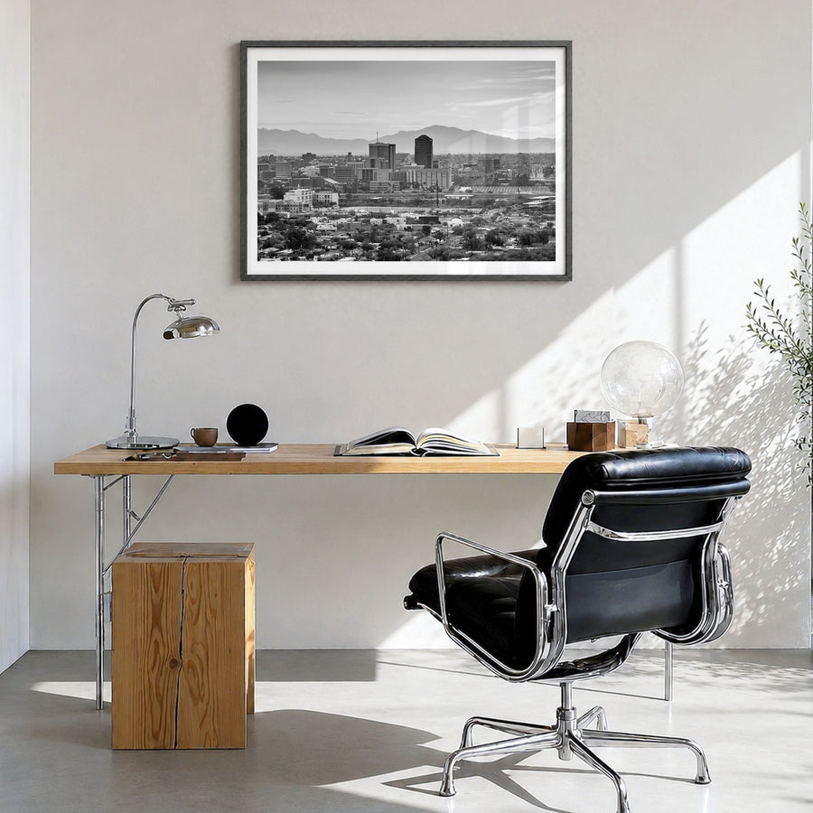Tucson Photo Poster in a black wood frame, hanging in a bright home office, white border