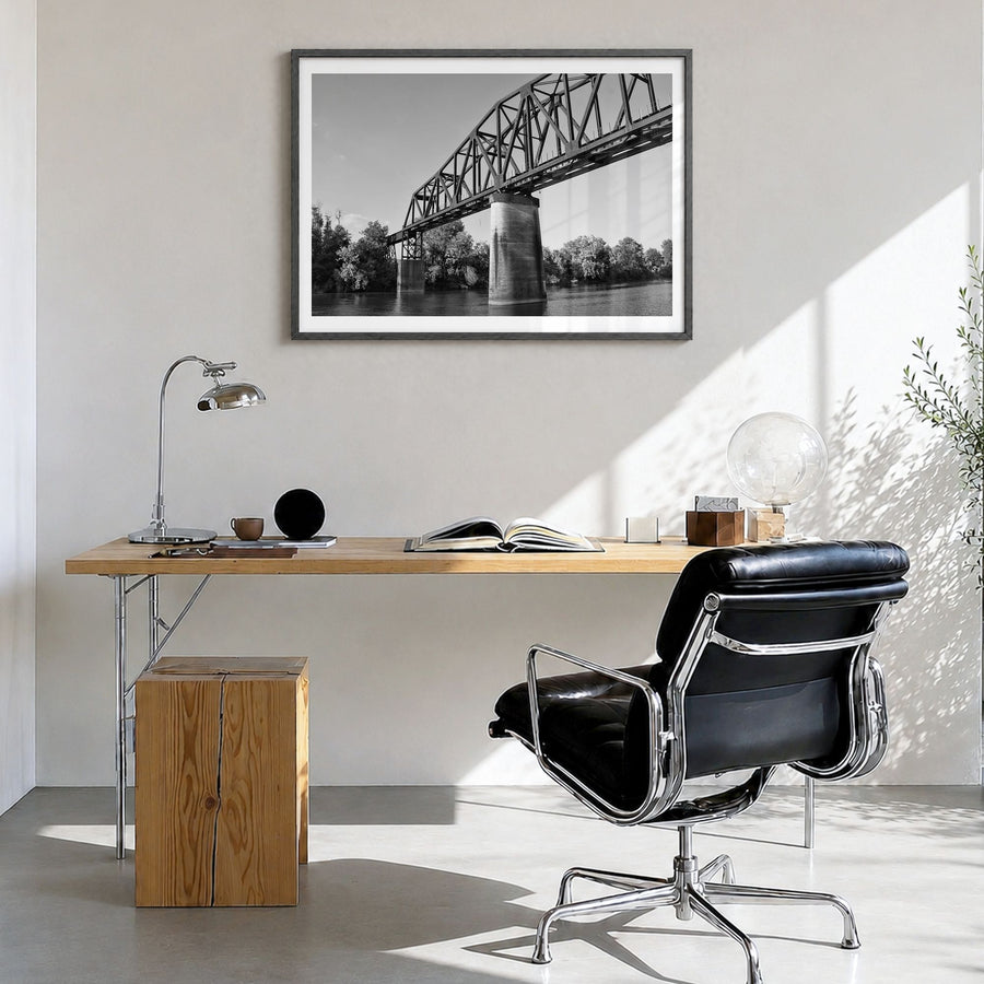 Tuscaloosa Photo Poster in a black wood frame, hanging in a bright home office, white border