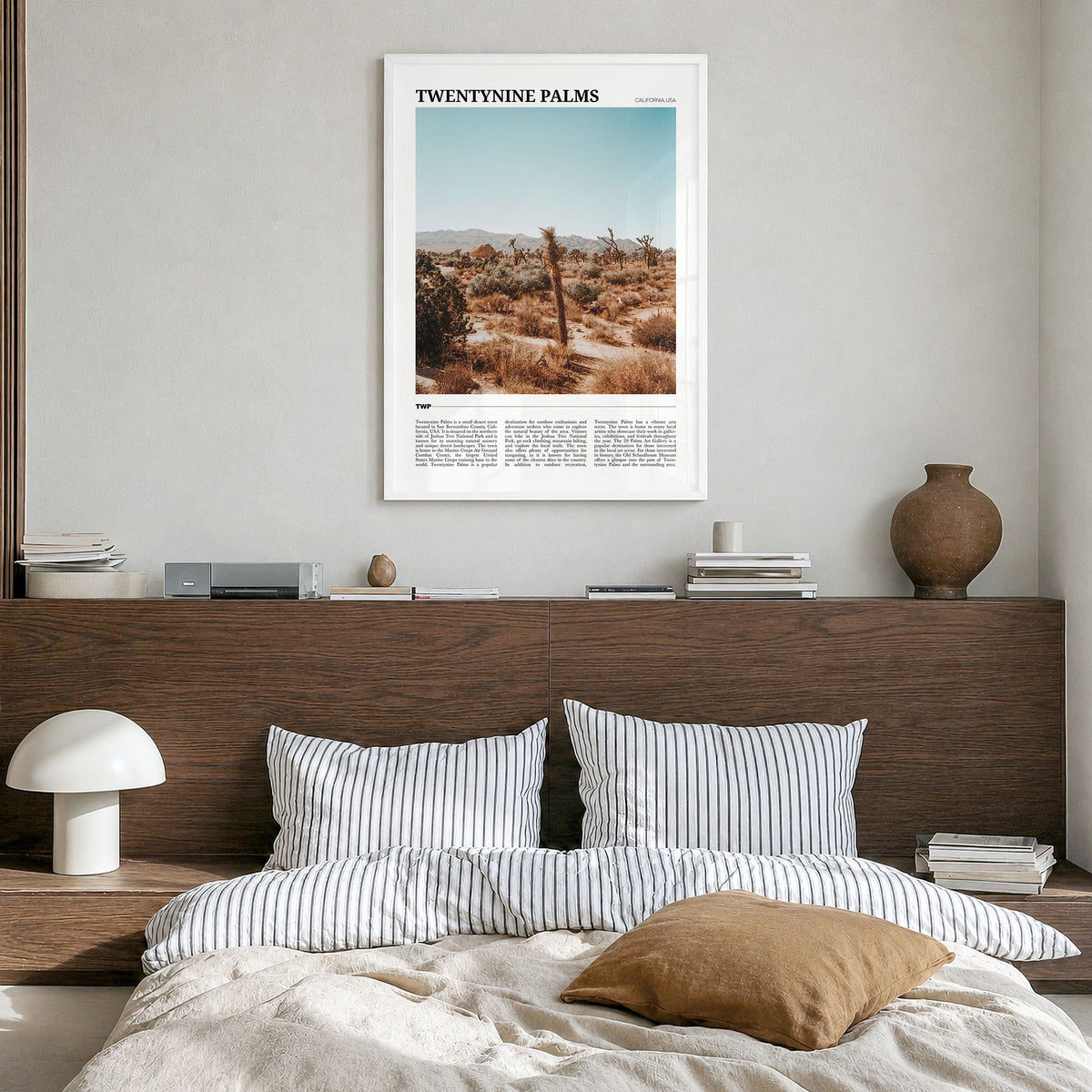 Twentynine Palms Travel Poster in a white wood frame, hanging in a bedroom