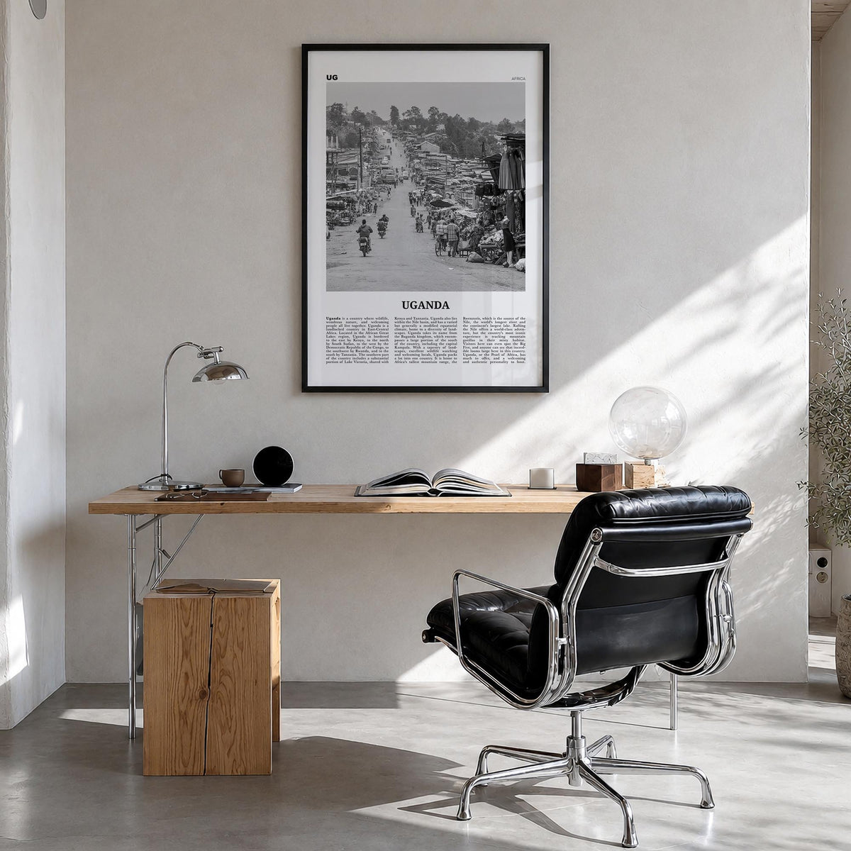 Uganda black & white newspaper poster of Africa – vertical wall art in black wood frame, hanging on wall