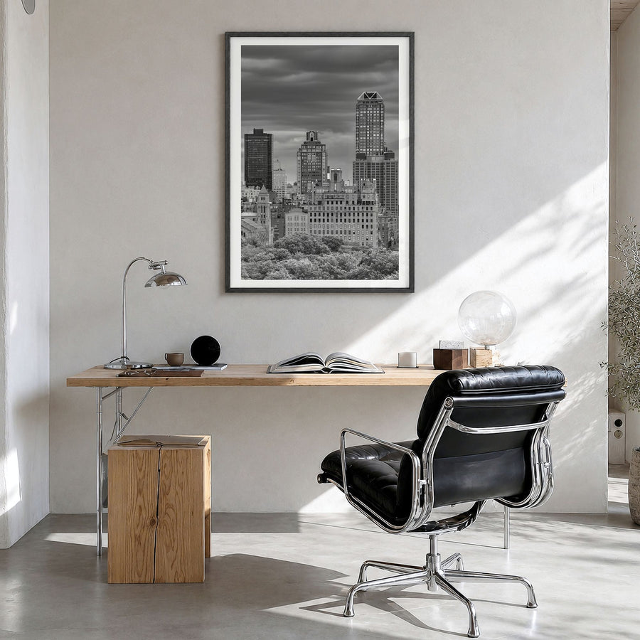 Upper East Side Photo Poster in a black wood frame, hanging in a bright home office, white border