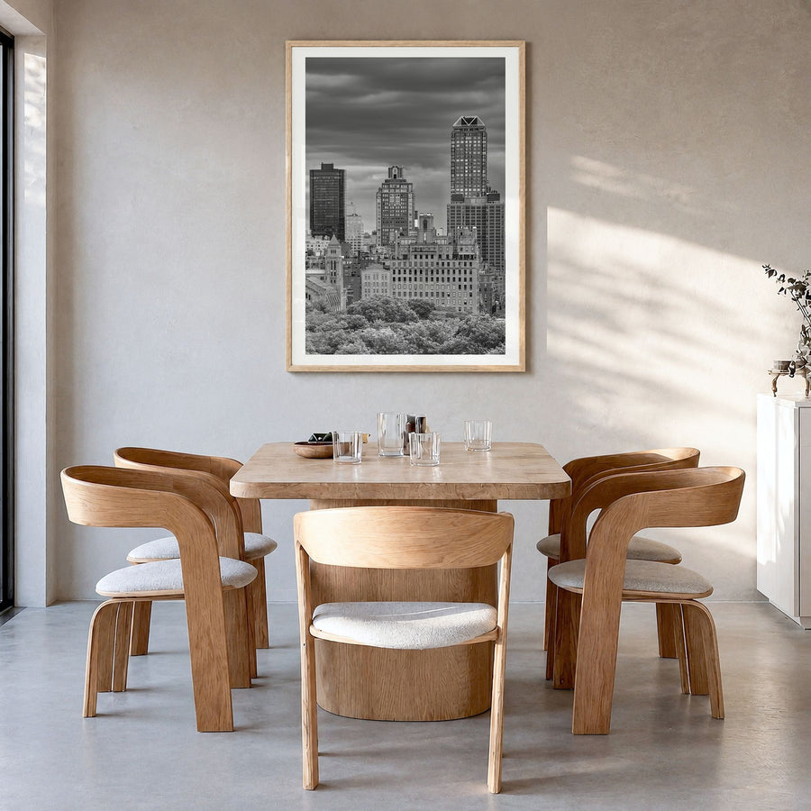 Upper East Side Photo Poster in a natural wood frame, hanging in a dining room, white border