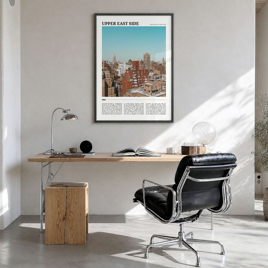 Upper East Side Travel Poster in a black wood frame, hanging in a bright home office
