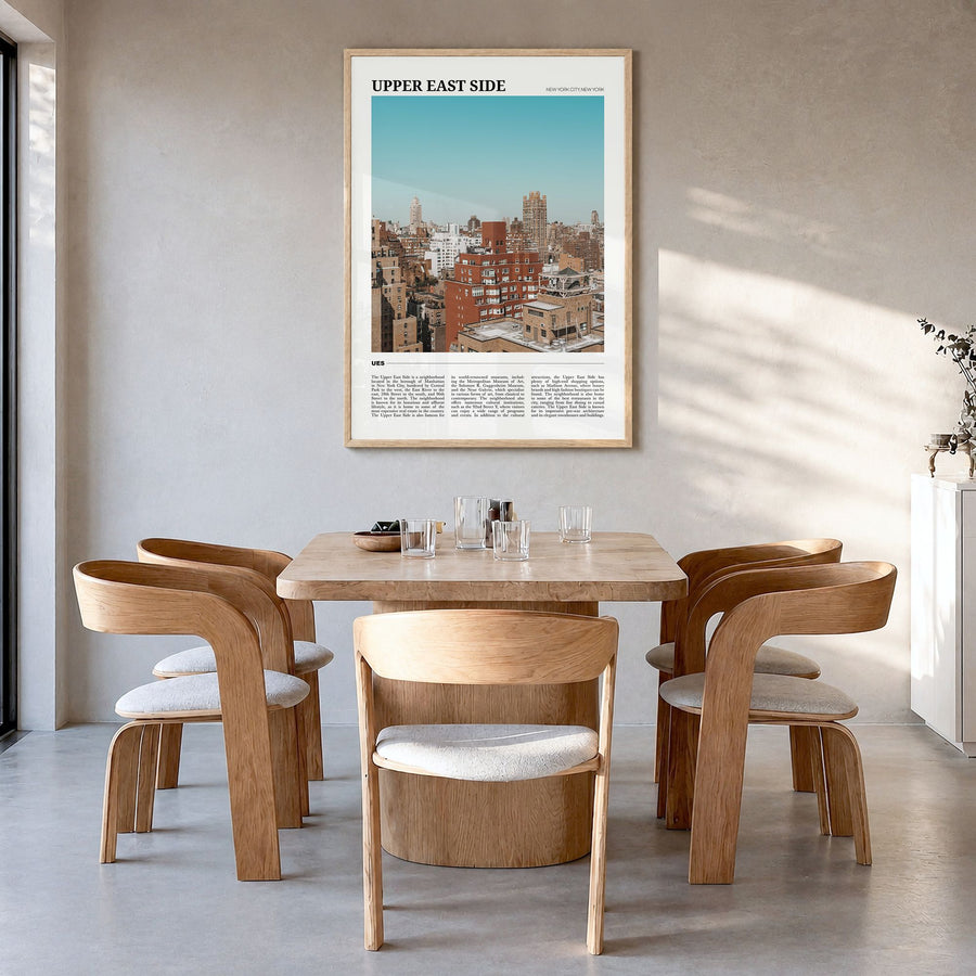 Upper East Side Travel Poster in a natural wood frame, hanging in a dining room