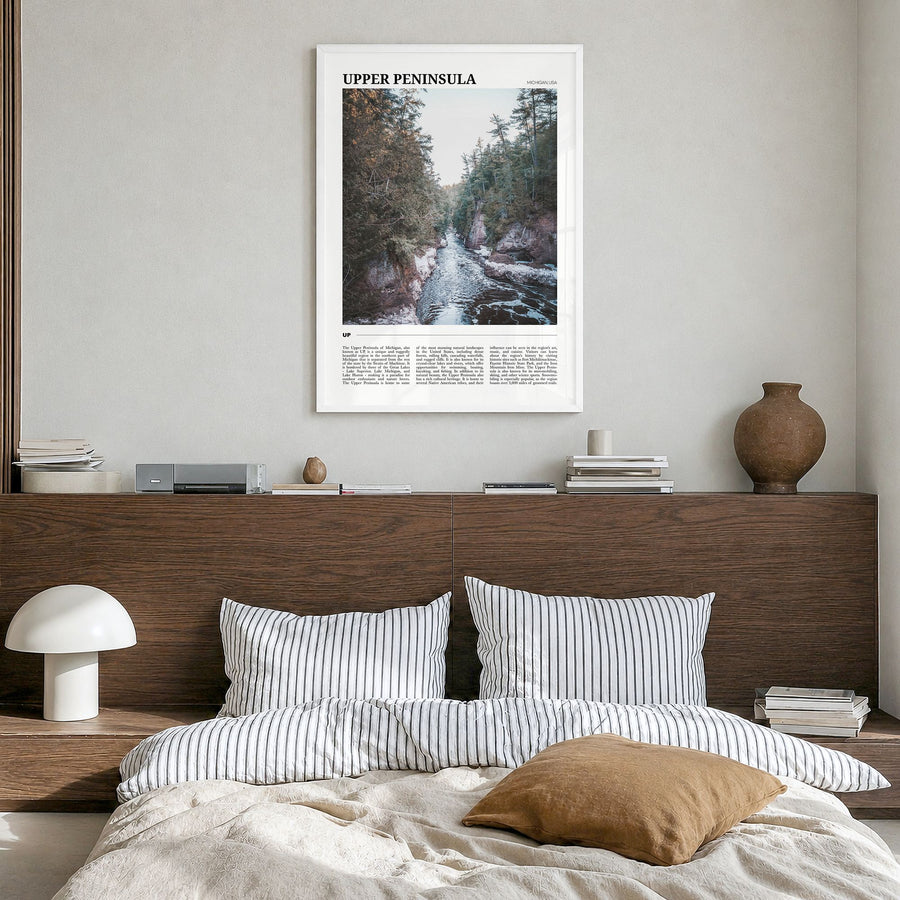 Upper Peninsula Travel Poster in a white wood frame, hanging in a bedroom