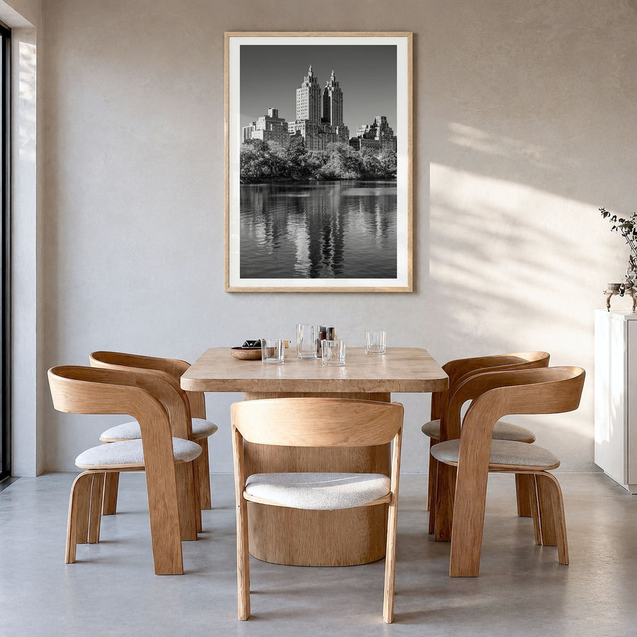 Upper West Side Photo No 2 Poster in a natural wood frame, hanging in a dining room, white border