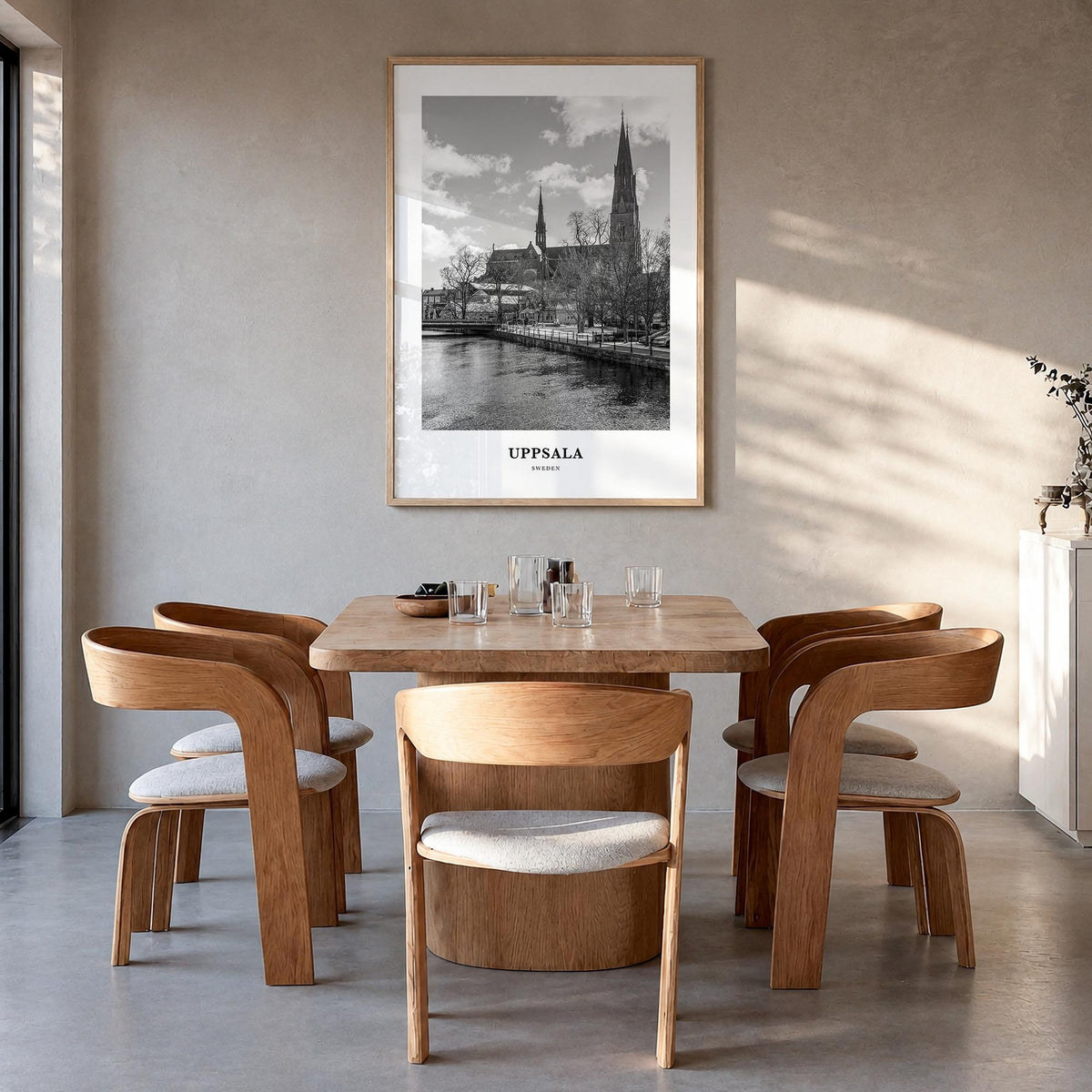 Uppsala black & white classic poster of Sweden – vertical wall art in natural wood frame, hanging on wall