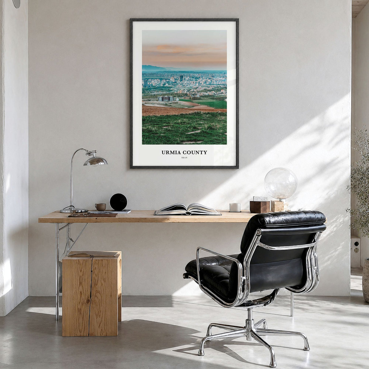 Urmia County Classic Poster in a black wood frame, hanging in a bright home office