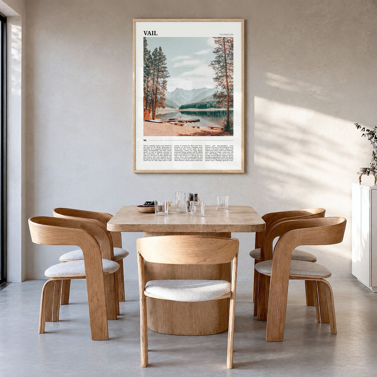 Vail Travel Poster in a natural wood frame, hanging in a dining room