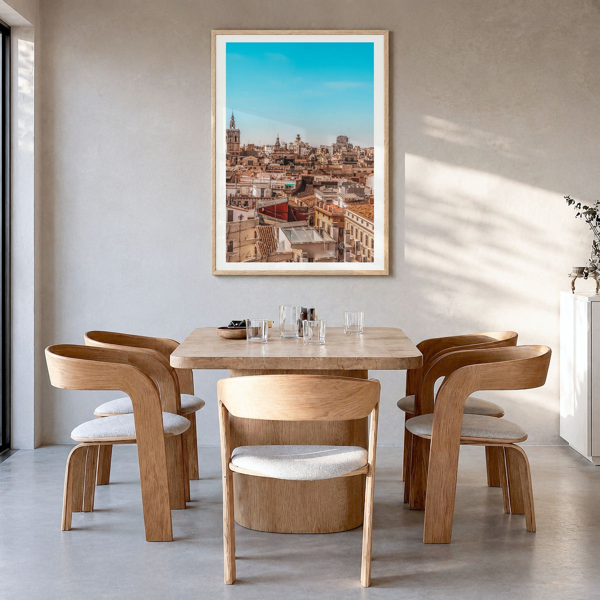 Valencia Photo Poster in a natural wood frame, hanging in a dining room, white border