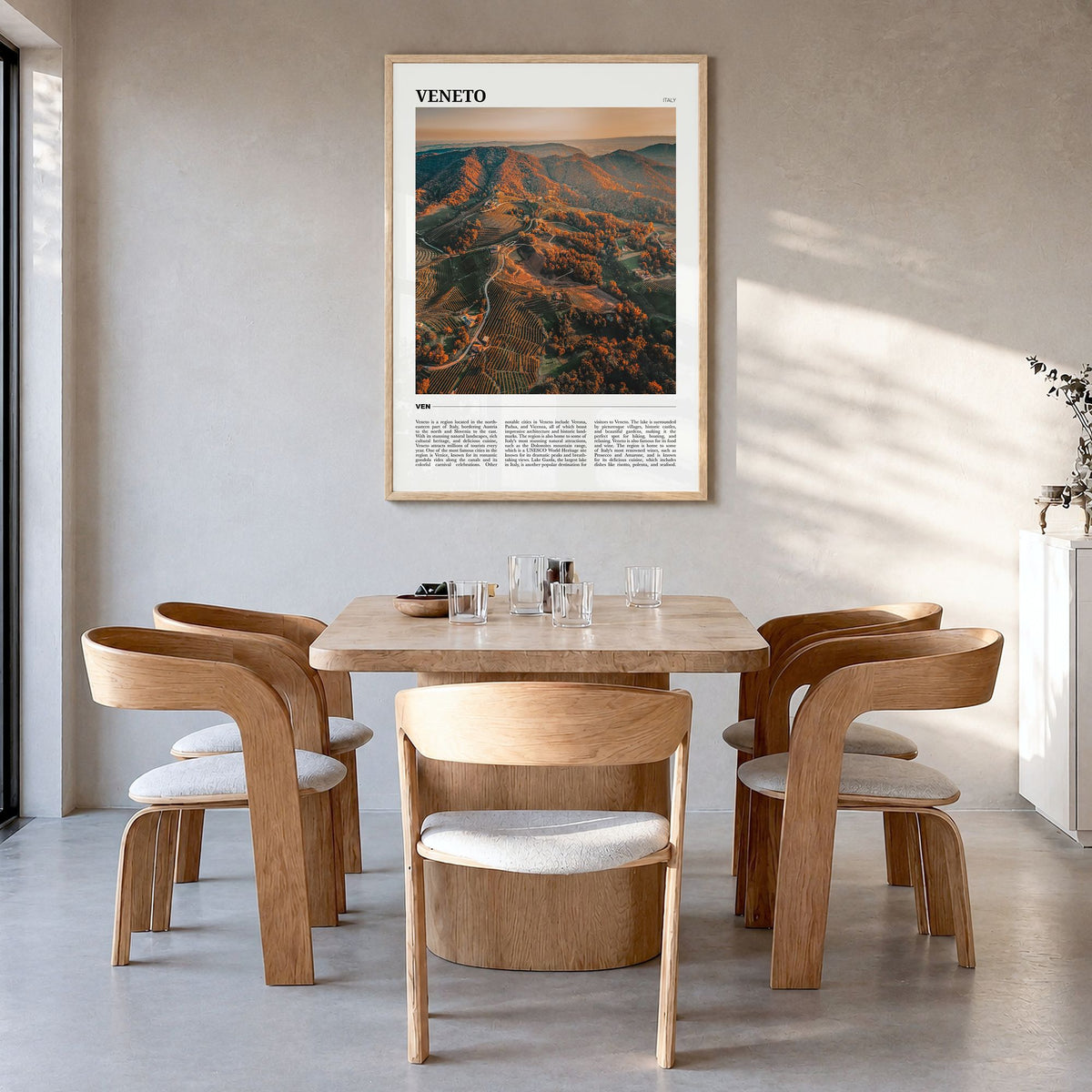 Veneto Travel Poster in a natural wood frame, hanging in a dining room