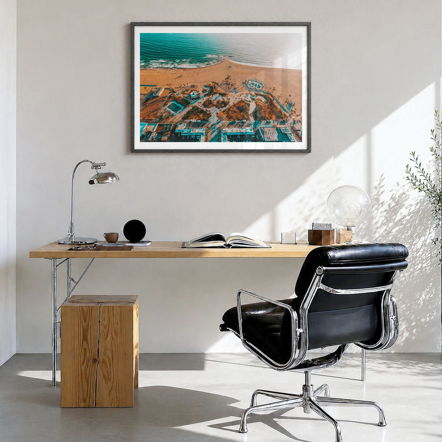 Venice Beach Photo Poster in a black wood frame, hanging in a bright home office, white border