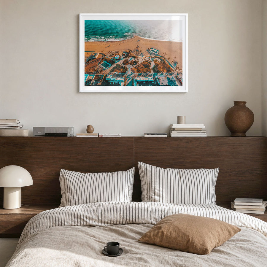 Venice Beach Photo Poster in a white wood frame, hanging in a bedroom, white border