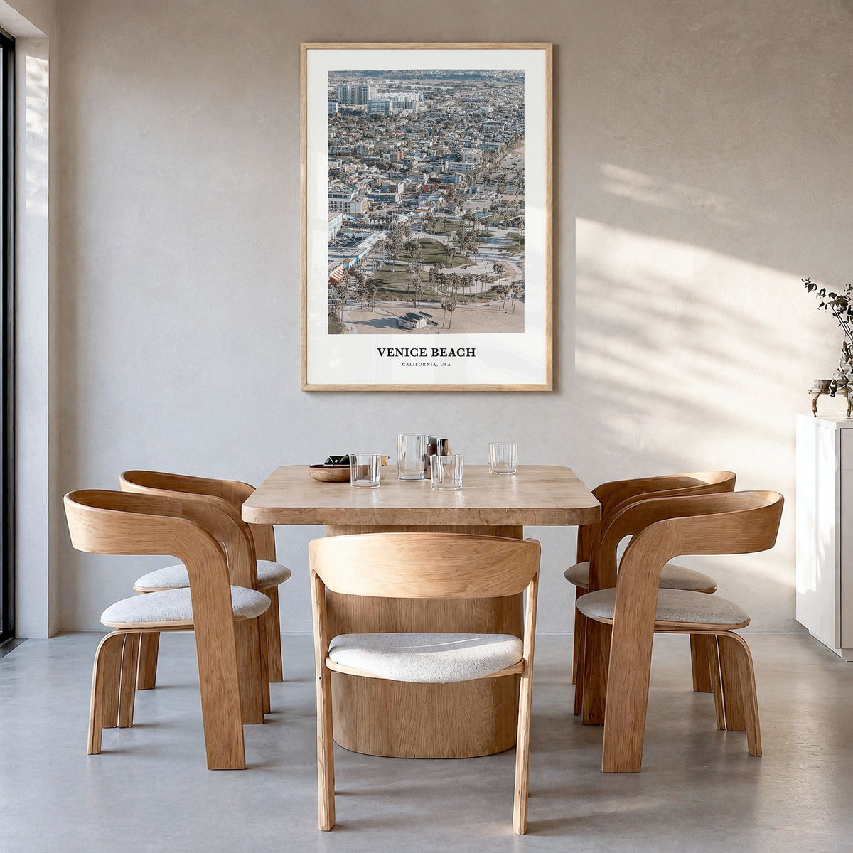 Venice Beach Classic Poster in a natural wood frame, hanging in a dining room