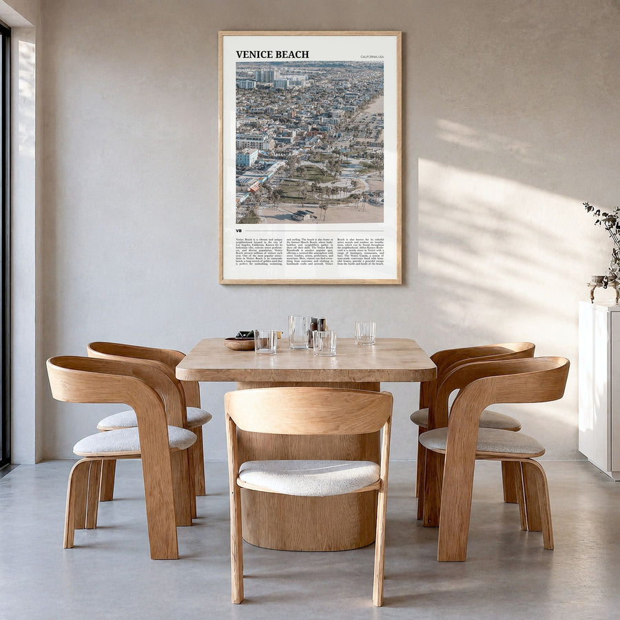 Venice Beach Travel Poster in a natural wood frame, hanging in a dining room