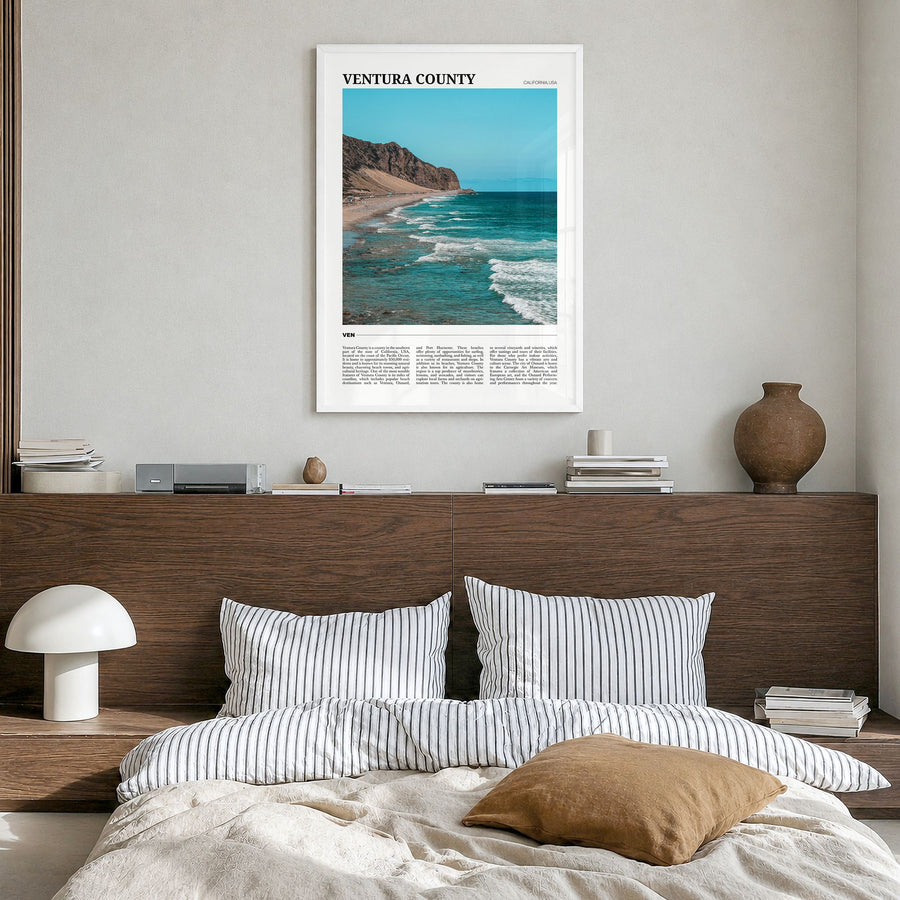 Ventura County Travel Poster in a white wood frame, hanging in a bedroom