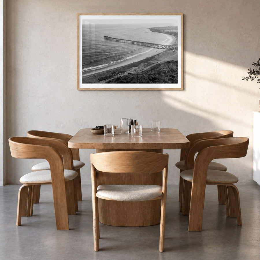 Ventura Photo No 1 Poster in a natural wood frame, hanging in a dining room, white border